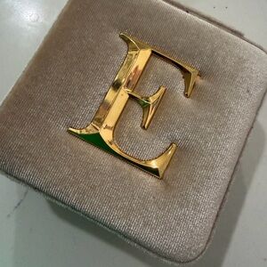 Gold jewelry box letter E